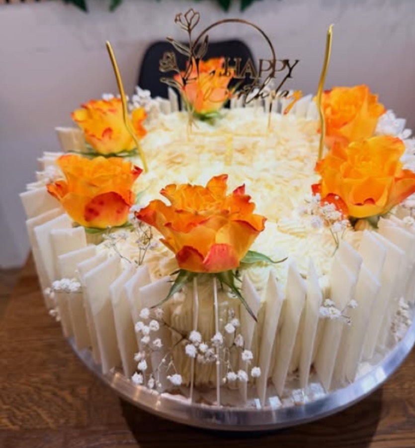 Geburtstagstorte mit orangen Rosen